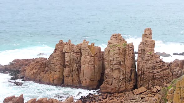 A shot of the wild ocean of Cape Woolamai Victoria Australia with the rugged cliffs of the pinnacles