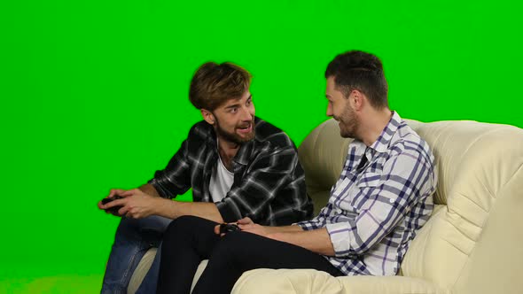 Men Compete in the Game on the Console. Green Screen