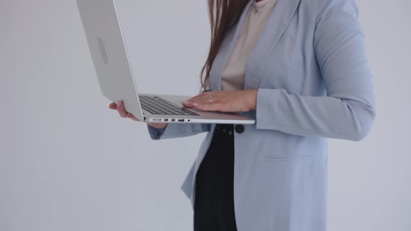 Closeup of Young Woman's Hand Scrolling Touchpad on Laptop on Isolated White Background