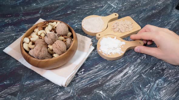 Various Gluten Free Flour on a Black Table with Nuts