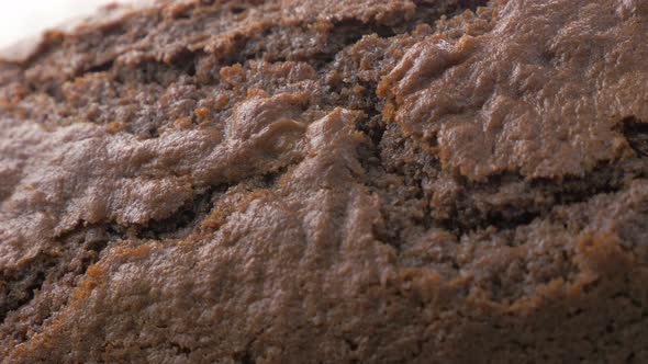 Crackled browny type shiny cake surface close-up panning 4K 3840X2160 UltraHD footage - Tasty lookin