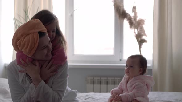 Authentic Cute Young Woman Hugging with Baby Girl