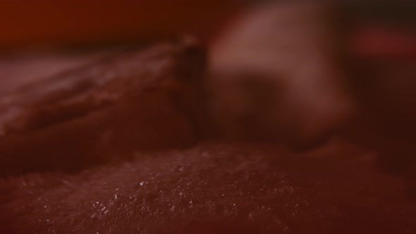 Closeup View of Hands in Gloves Packing Chicken Legs From a Box Into Individual Plastic Bags