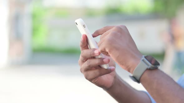 Close Up of African Man Using Smartphone