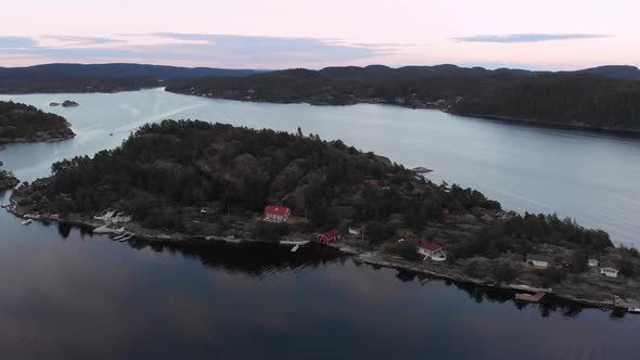 Kragerofjorden and its holiday cabins, beautiful sunset colors on drone flight