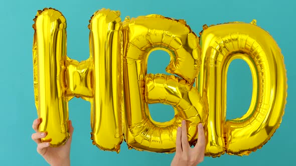 Golden HAPPY BIRTHDAY Words Made of Inflatable Balloons