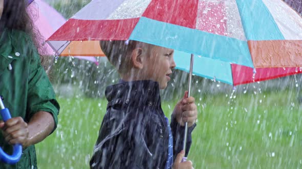 Ecstatic Children Enjoying Rainy Day