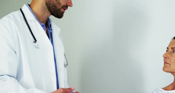 Male doctor comforting patient in the ward