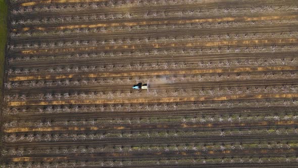 Aerial View of a Tractor Using a Air Dust Machine Sprayer with a Chemical