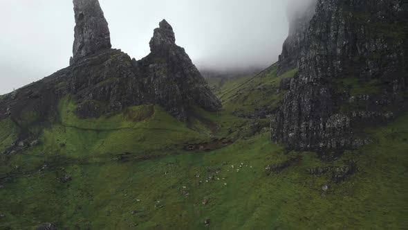 Aerial drone view of old man of storr in isle of Skye scotland, green landscape during  a cloudy day