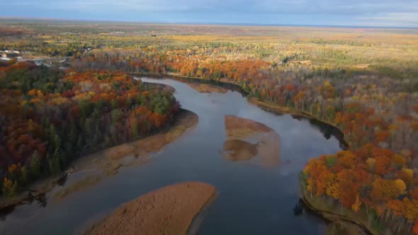 Upper drone view of fall colors along a winding river.