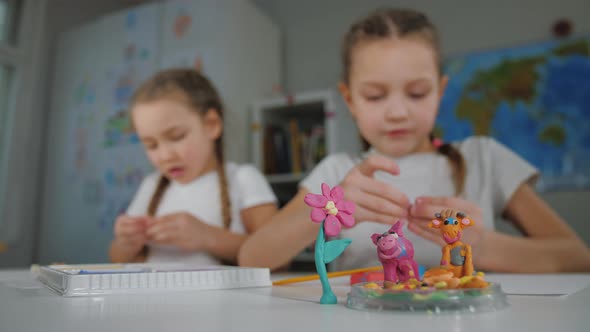 Two Preschool Girls Making Toys Sculpting Playdough Sculpts From Plasticine