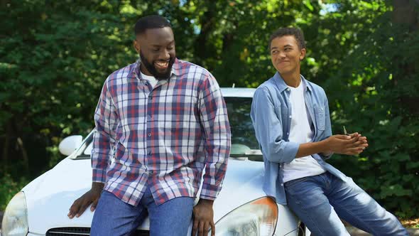 Happy Son Receiving Auto Key From Father Getting in Car, Male Hobby, Transport