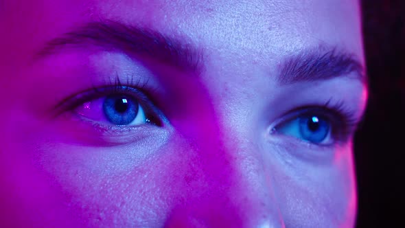 Closeup of Woman Eyes in the Ultraviolet Light