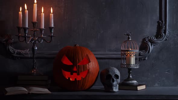 Scary laughing pumpkin and an old skull over the frightening gothic background.