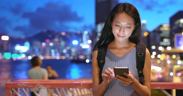 Woman looking at mobile phone at night 