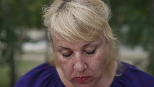 Fat Mature Woman Eating a Bun