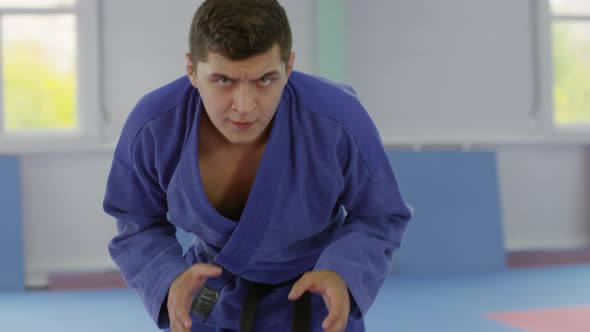 Male and Female Jujitsu Athletes Posing and Fighting in Gym