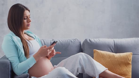 Young pregnant woman is resting at home and expecting a baby.