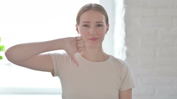 Portrait of Woman Showing Thumbs Down