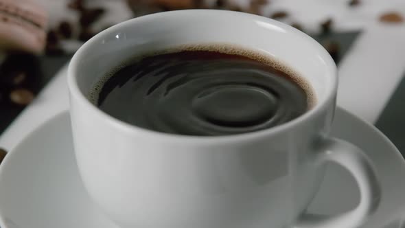 Water Drop Falling Into a Fresh Morning Coffee