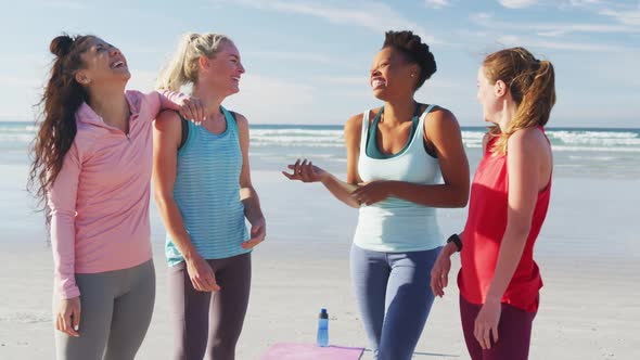 Happy group of diverse female friends having fun at the beach