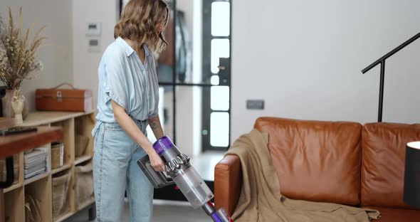 Woman Vacuuming Floor with Cordless Cleaner