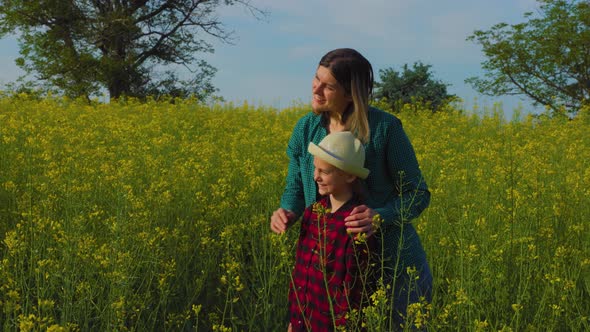 Mother and Daughter Farming Family in the Rapeseed Field