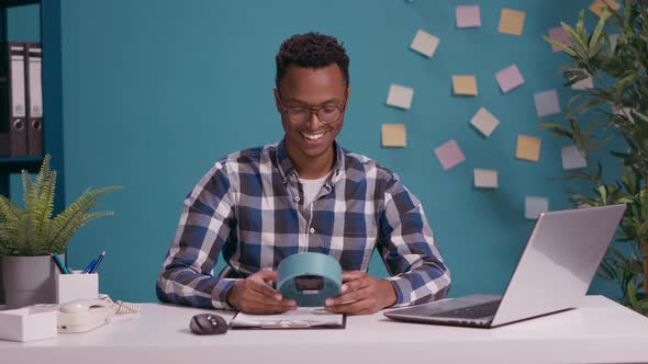 Pleased Man Looking at Time on Clock and Finishing Work