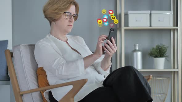 Relaxing Old Woman Using Smartphone Emojis Smileys and Likes