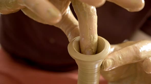 Experienced Potter Creating a Beautiful Clay Vase Using Professional Tools