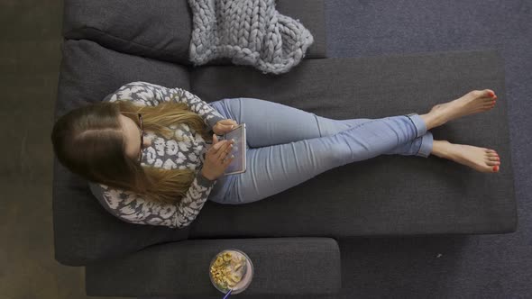 Top View of Woman Using Digital Tablet Pc on Sofa