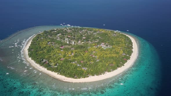 Aerial forward tracking shot panning down of Balicasag Island, Bohol, the Philippines