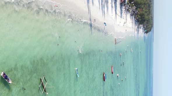 Vertical Video Boats in the Ocean Near the Coast of Zanzibar Tanzania Aerial View