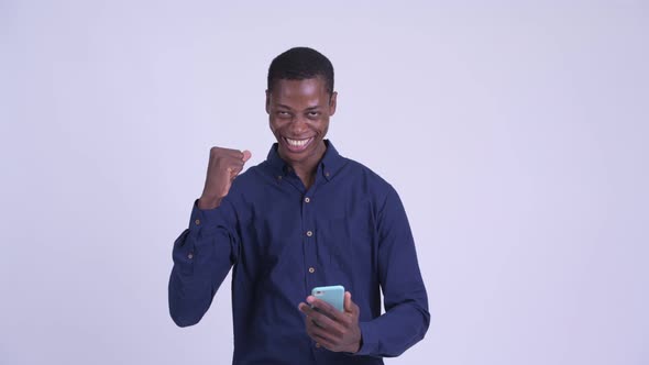 Young Happy African Businessman Using Phone and Getting Good News