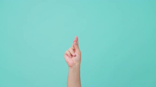 Close up shot of male hand raising with finger snapping gesture in isolate blue screen in background