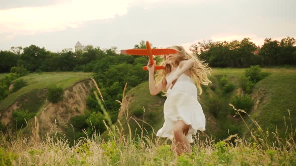 Child Girl Playing With The Toy Airplane