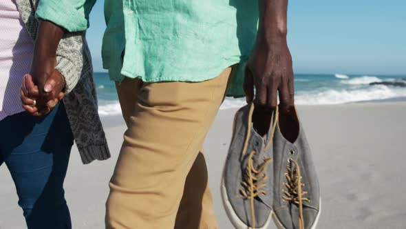 Senior couple walking at the beach