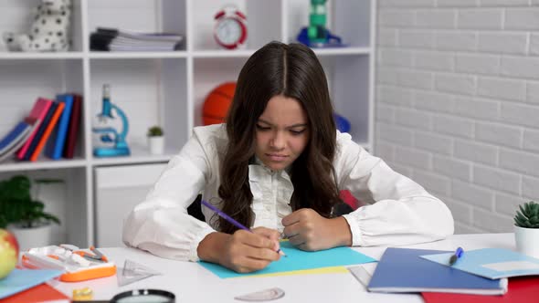 Serious Female Student in School Uniform Writing Trying to Solve Math Problem Study