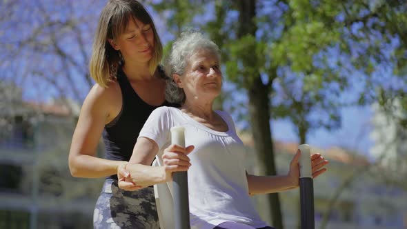 Smiling Senior Woman Training with Personal Trainer.