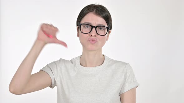 Young Woman Showing Thumbs Down on White Background