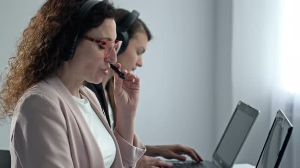 Call Center Operators Wearing Headphones