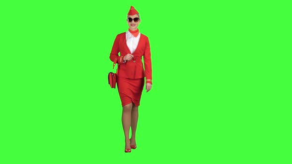 Girl in Sunglasses Is Walking. Green Screen