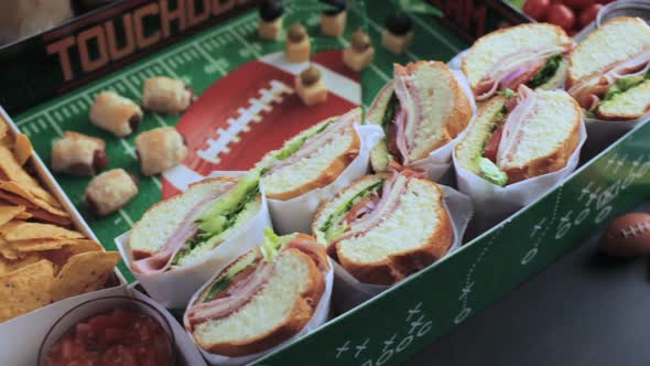 Football Snack Stadium filled with sub sandwiches, veggies and chips.