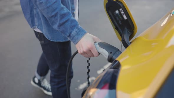 slow motion Electric car on charge  outside house