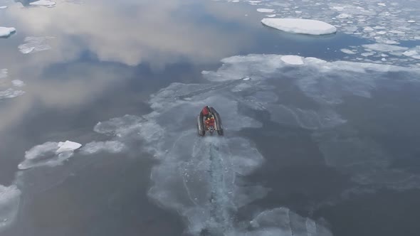 Aerial View of People in Expedition Boat Sail in Brash Ice Water.