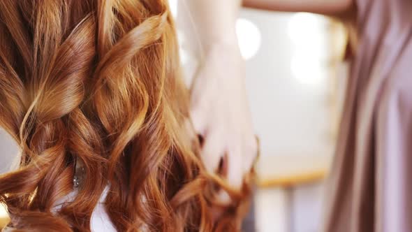 Hairdresser Making Hairstyle to Foxy Girl in Beauty Salon Slow Motion Close Up