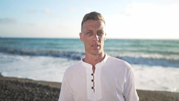 Portrait of Young Caucasian Man Posing at Mediterranean Tourist Resort with Turquoise Azure Waves