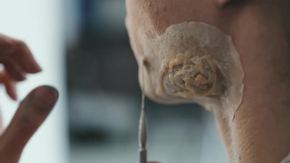 Close Up of Applying Prosthetic Scar on Man