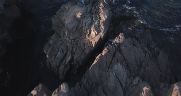 Rock and blue sea at sunset